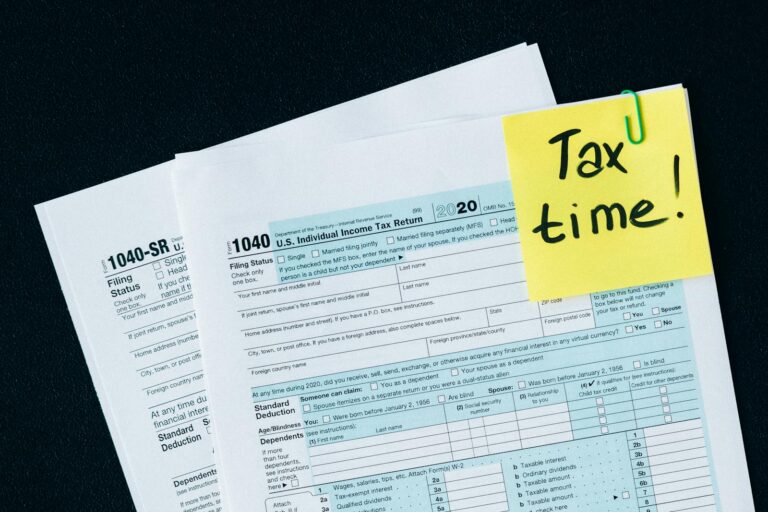 California’s High-Tax Exodus: Wealth Drains, Opportunities Flee U.S. tax documents with a 'Tax time!' reminder, highlighting the importance of filing deadlines.