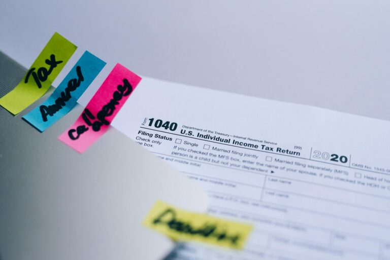 Wealth Preservation: California’s Tax Plan Sparks Billionaire Financial Shifts Close-up of 1040 U.S. tax form with colorful sticky notes for organization.